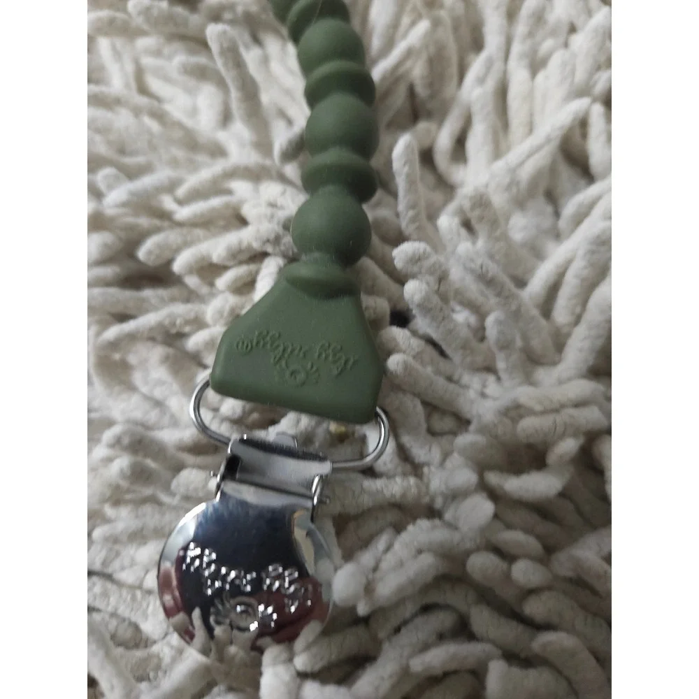 Itzy Ritzy silicone pacifier clip in a sage green color